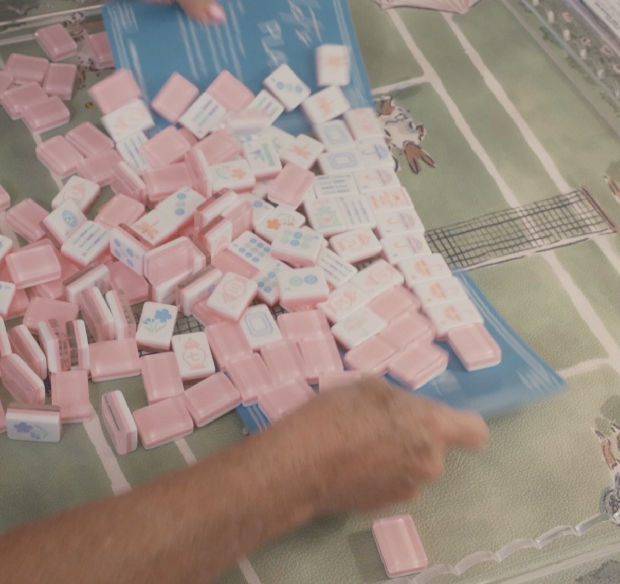 Pink mahjong tiles spilling onto the mat